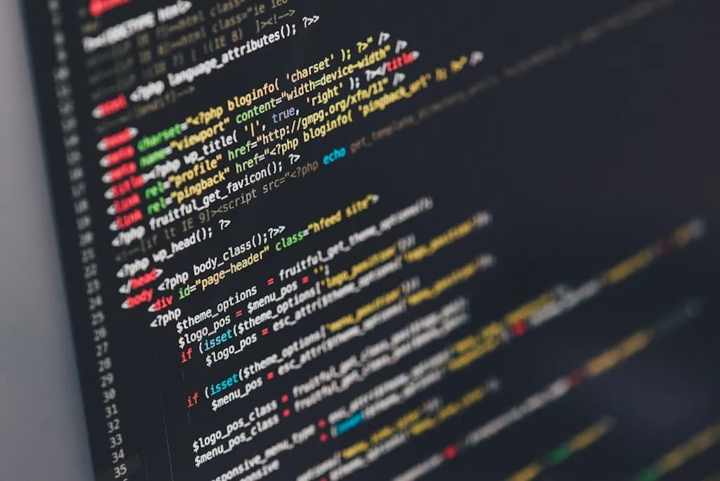 Developer working on code with multiple screens